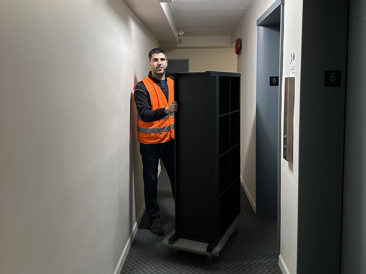 Eco Van Move staff transporting a cabinet during a furniture pickup and delivery service in Vancouver.