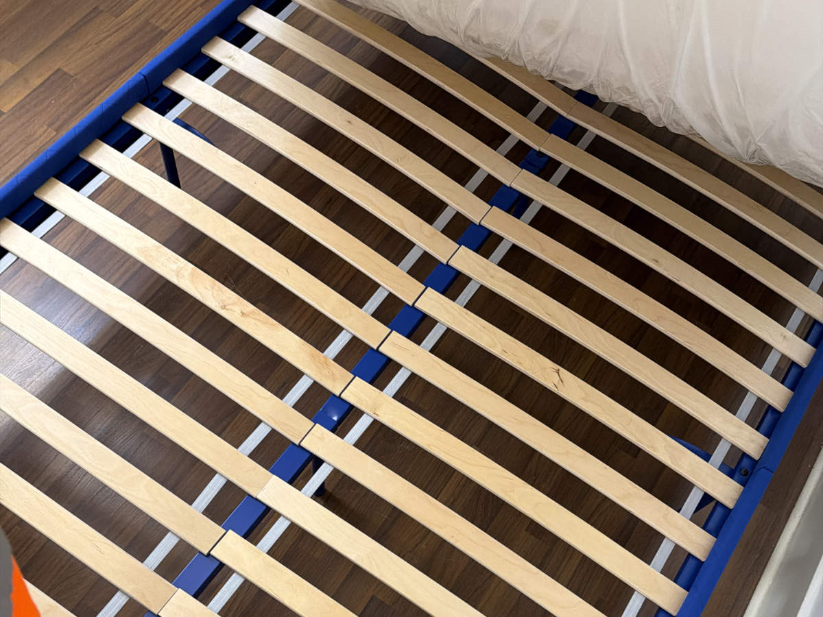 Eco Van Move inspecting a bed frame and mattress during a Facebook Marketplace pickup for a client.