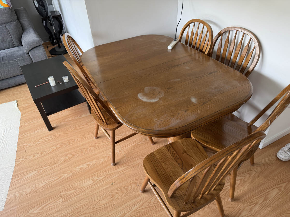 Wooden dining table and chair set inspected during a Facebook Marketplace pickup for client delivery.