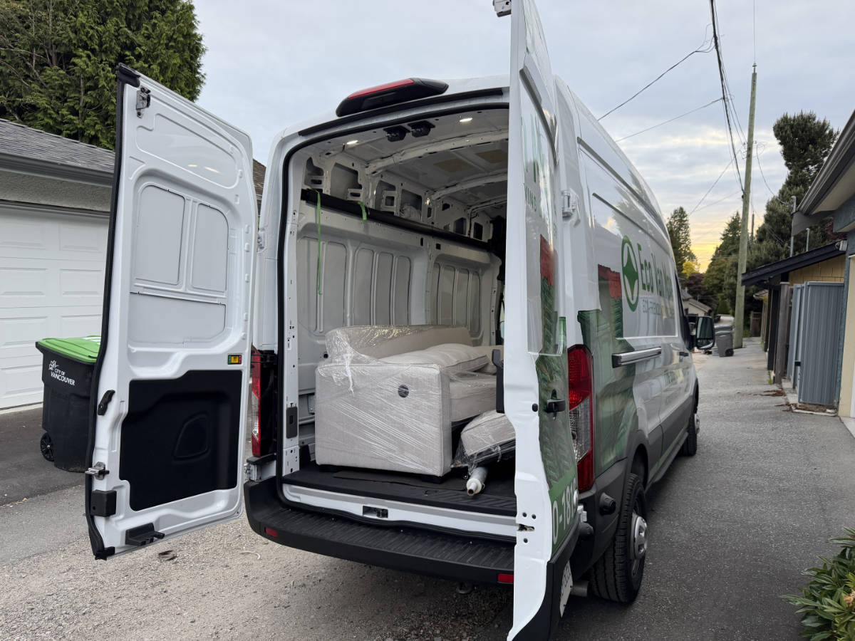 Sofa bed securely loaded in an Eco Van Move cargo van for furniture delivery in Metro Vancouver.