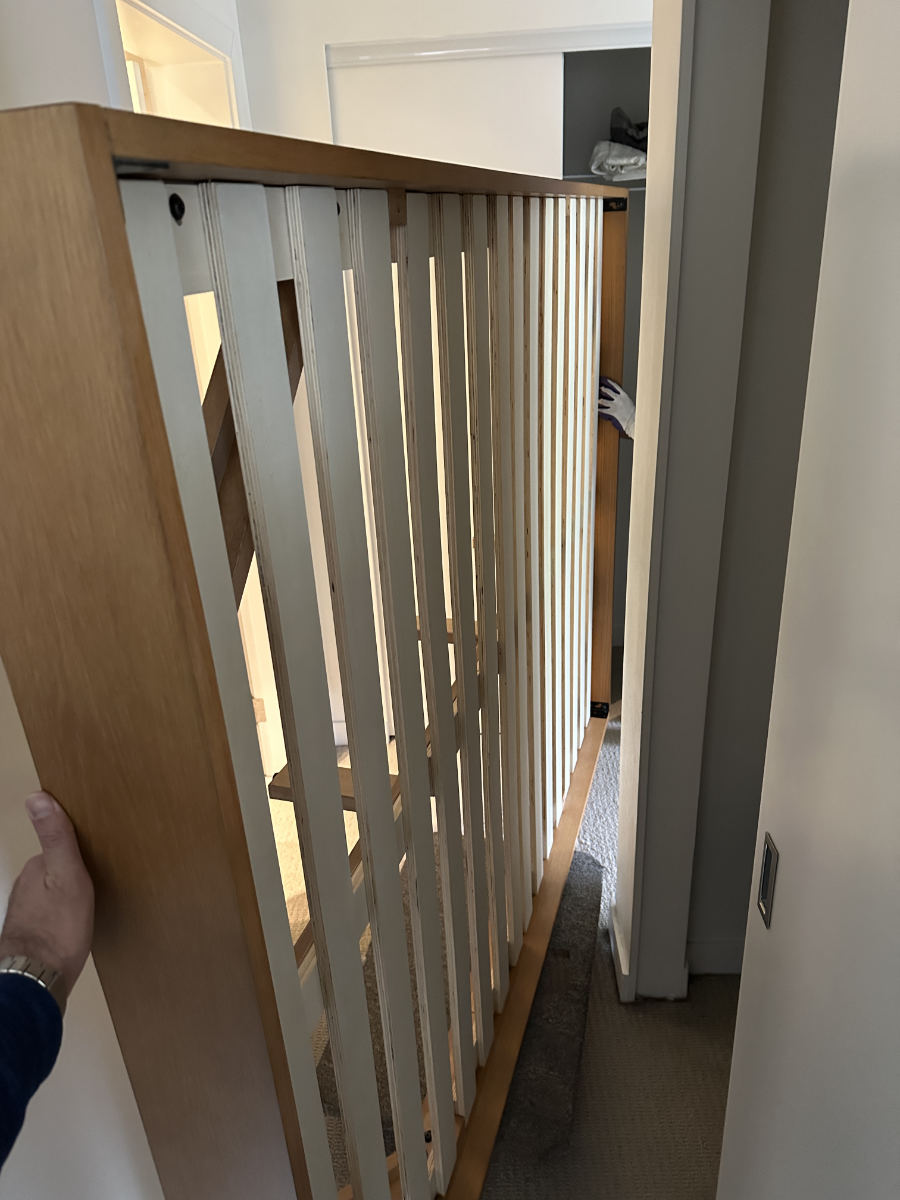Eco Van Move carefully maneuvering a bed frame through a narrow hallway without disassembly during a move.