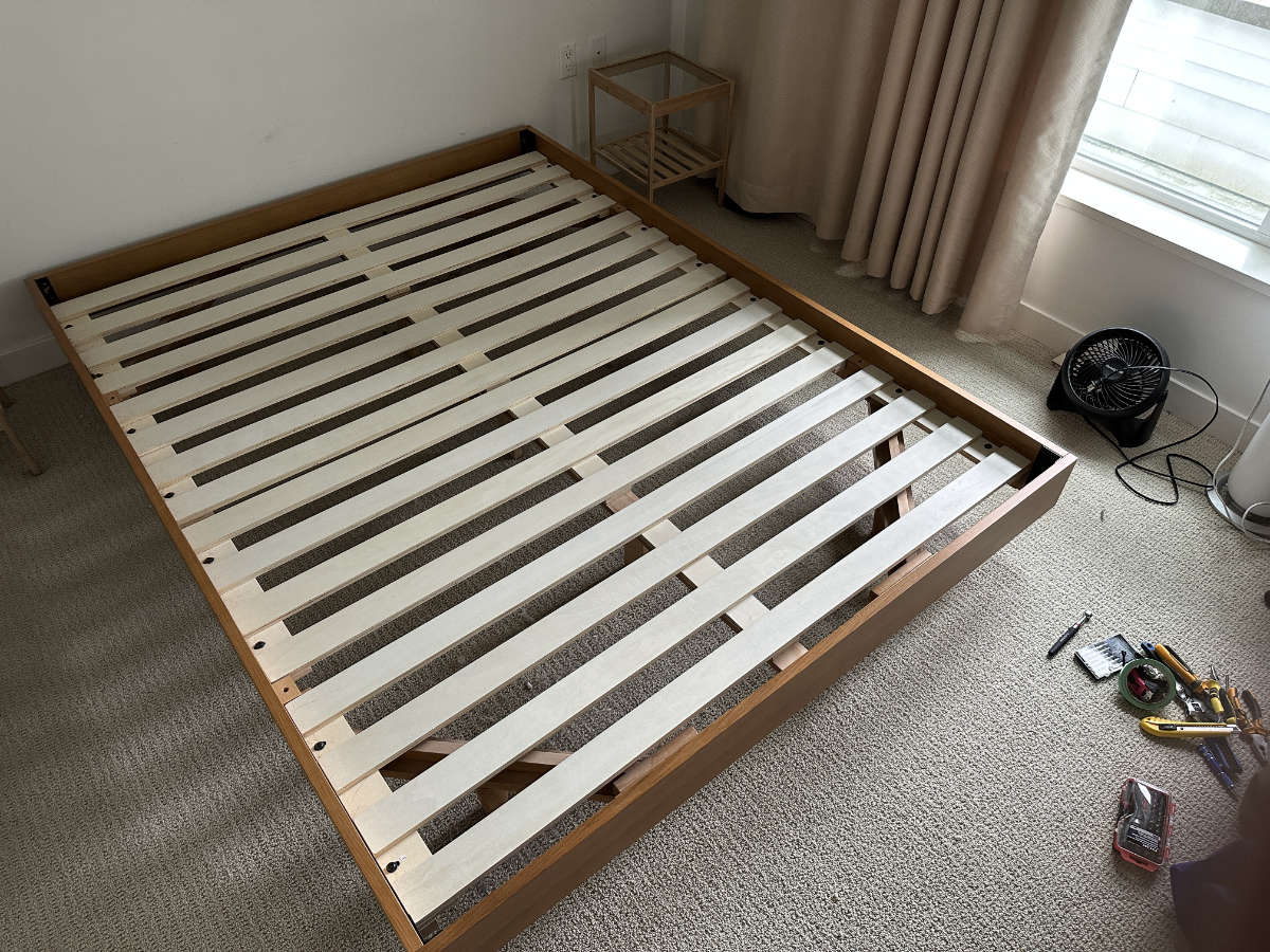 Eco Van Move disassembling a wooden bed frame in preparation for a residential move in Vancouver.