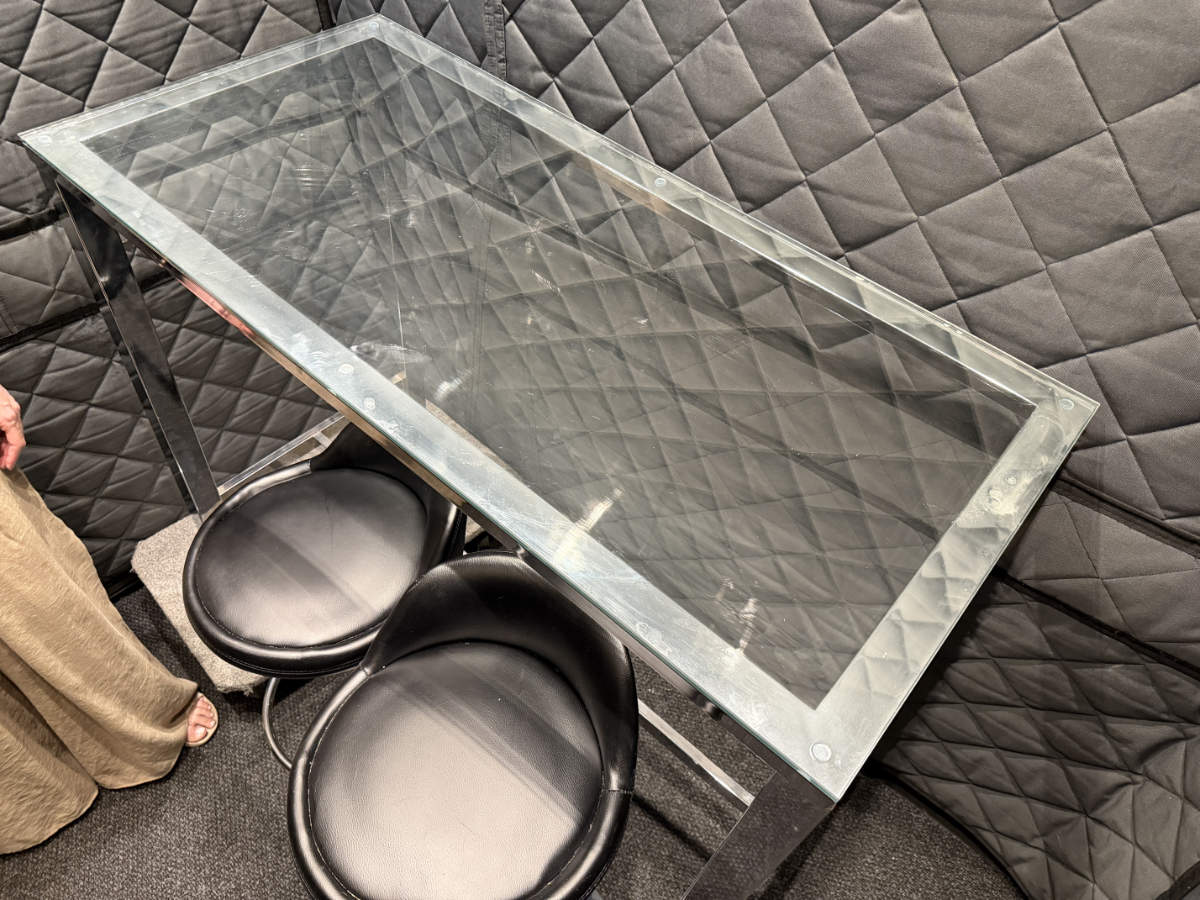 Glass dining table and chairs secured inside a padded delivery van for safe transport.